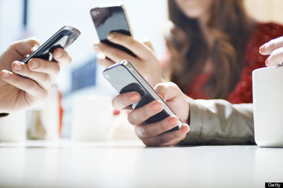 hands texting with mobile phones in cafe