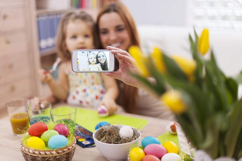 Mother and daughter taking self portrait while easter time
